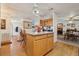 Open kitchen with a center island and wood cabinets adjacent to a dining area at 1901 Brookside Dr, Mount Dora, FL 32757