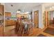 Charming kitchen with wood cabinets and a dining area with natural light at 1901 Brookside Dr, Mount Dora, FL 32757