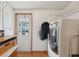 Bright laundry room featuring a modern washing machine and exterior access at 1901 Brookside Dr, Mount Dora, FL 32757