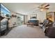 Cozy living room with a fireplace, sliding glass door, and comfortable leather furniture at 1901 Brookside Dr, Mount Dora, FL 32757