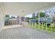 Inviting covered porch with patterned tile flooring and white railings; perfect for relaxing outdoors at 1901 Brookside Dr, Mount Dora, FL 32757