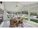 Inviting sunroom with tile floors, ceiling fan, and an abundance of natural light at 1901 Brookside Dr, Mount Dora, FL 32757