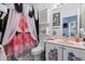 Whimsical bathroom with patterned shower curtain and pink sink, offering a unique, playful aesthetic at 1917 Peachtree Ave, The Villages, FL 32162