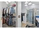 Bright bathroom includes a glass-enclosed walk-in shower, neutral tile, and access to a walk-in closet at 1917 Peachtree Ave, The Villages, FL 32162