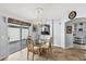 Cozy dining room featuring a chandelier, glass table with seating for four, and sliding glass door to the outdoor patio at 1917 Peachtree Ave, The Villages, FL 32162
