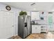 Bright kitchen with stainless steel refrigerator, white cabinets, and ample countertop space for cooking and prep at 1917 Peachtree Ave, The Villages, FL 32162