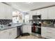 Bright kitchen with modern appliances, granite countertops and white cabinetry at 1917 Peachtree Ave, The Villages, FL 32162
