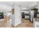 Modern kitchen with stainless steel appliances, granite countertops, and adjacent dining area with chandelier at 1917 Peachtree Ave, The Villages, FL 32162