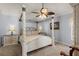 Main bedroom with a four poster bed, side tables, and lamps at 1917 Peachtree Ave, The Villages, FL 32162