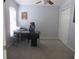 Bright office space with a modern black desk, rolling chair, carpet flooring, and a large window providing natural light at 1917 Peachtree Ave, The Villages, FL 32162