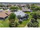 Aerial view of the property, highlighting the screened lanai and lush surrounding landscaping at 1992 Hagood Loop, The Villages, FL 32162