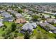 Community aerial showcasing the neighborhood layout, with lush landscaping and nearby lake at 1992 Hagood Loop, The Villages, FL 32162