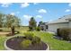 The house features a manicured lawn and beautiful landscaping at 1992 Hagood Loop, The Villages, FL 32162