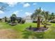 Expansive backyard with lush landscaping, well-manicured lawn, and a screened-in patio for outdoor entertaining at 1992 Hagood Loop, The Villages, FL 32162