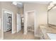 Bathroom featuring granite countertops, dual sinks, vanity and convenient walk-in closet at 1992 Hagood Loop, The Villages, FL 32162