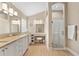 Elegant bathroom with granite counters, makeup vanity, and glass-enclosed shower at 1992 Hagood Loop, The Villages, FL 32162
