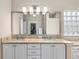 Bathroom featuring double sinks, granite countertops, and ample storage at 1992 Hagood Loop, The Villages, FL 32162