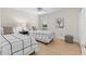 Bright bedroom with two twin beds, wood floors, and a ceiling fan at 1992 Hagood Loop, The Villages, FL 32162