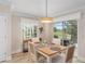 Charming dining area with views of the outdoor patio and golf course at 1992 Hagood Loop, The Villages, FL 32162