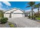 Beautiful home with well-maintained landscaping, a paver driveway, and a spacious two-car garage at 1992 Hagood Loop, The Villages, FL 32162