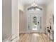 Bright and airy foyer with decorative glass front door and hardwood floors, showcasing the home's entry at 1992 Hagood Loop, The Villages, FL 32162