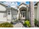 Close-up of a home's front entrance with a decorative glass door and manicured landscaping at 1992 Hagood Loop, The Villages, FL 32162
