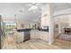 Spacious kitchen with granite countertops, stainless dishwasher, and light wood floors at 1992 Hagood Loop, The Villages, FL 32162
