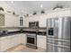 Well-equipped kitchen showcasing stainless steel appliances and custom cabinetry at 1992 Hagood Loop, The Villages, FL 32162