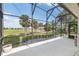 The screened lanai boasts a view of the golf course and lush landscaping at 1992 Hagood Loop, The Villages, FL 32162
