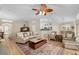 Inviting living room featuring light wood floors, comfortable seating, and access to the kitchen and dining area at 1992 Hagood Loop, The Villages, FL 32162