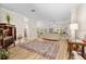 Bright, open-concept living room with wood floors and large windows overlooking the outdoors at 1992 Hagood Loop, The Villages, FL 32162