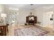 Bright living room featuring an elegant front door and a stylish decorative cabinet at 1992 Hagood Loop, The Villages, FL 32162