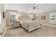 Inviting bedroom with tray ceilings, fan, and plenty of natural light at 1992 Hagood Loop, The Villages, FL 32162