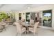 Covered outdoor living space featuring comfortable seating with access to interior at 1992 Hagood Loop, The Villages, FL 32162