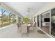 Spacious covered outdoor living space featuring comfortable seating and a golf course view at 1992 Hagood Loop, The Villages, FL 32162