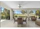 Covered outdoor living space features comfortable seating with a view of the golf course at 1992 Hagood Loop, The Villages, FL 32162