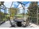 The outdoor dining area sits on the screened in patio and offers beautiful views at 1992 Hagood Loop, The Villages, FL 32162