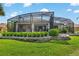 Spacious screened-in patio with an open design, perfect for outdoor dining and relaxation overlooking the lush lawn at 1992 Hagood Loop, The Villages, FL 32162