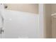Shower featuring white tiling, hand rails and adjustable shower head at 1992 Hagood Loop, The Villages, FL 32162