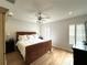 Inviting bedroom features a comfortable bed, stylish ceiling fan, and natural light from shuttered windows at 2261 Osprey Ave, Orlando, FL 32814