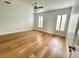 Bright bedroom featuring wood floors, plantation shutters, and ceiling fan at 2261 Osprey Ave, Orlando, FL 32814