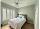 Comfortable bedroom with hardwood floors, neutral walls, ceiling fan, and plantation shutters at 2261 Osprey Ave, Orlando, FL 32814