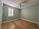 Bedroom with hardwood floors, a ceiling fan, and plantation shutters at 2261 Osprey Ave, Orlando, FL 32814