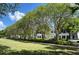 Scenic view of the community featuring manicured lawns, mature trees, and charming townhomes at 2261 Osprey Ave, Orlando, FL 32814
