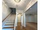 Bright foyer showcasing hardwood floors, staircase with wooden railing, and modern lighting fixtures at 2261 Osprey Ave, Orlando, FL 32814