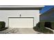 Attached garage with a classic white door and manicured landscaping at 2261 Osprey Ave, Orlando, FL 32814