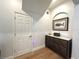 Hallway with hardwood floors, white trim, and built-in niche with decorative furnishings at 2261 Osprey Ave, Orlando, FL 32814