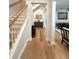 Well-lit hallway featuring hardwood floors, neutral paint, and decorative accents at 2261 Osprey Ave, Orlando, FL 32814