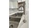 Close up of stainless steel, dual basin kitchen sink, modern faucet, and sleek quartz countertop at 2261 Osprey Ave, Orlando, FL 32814