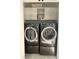 Laundry closet with washer, dryer and overhead cabinets at 2261 Osprey Ave, Orlando, FL 32814